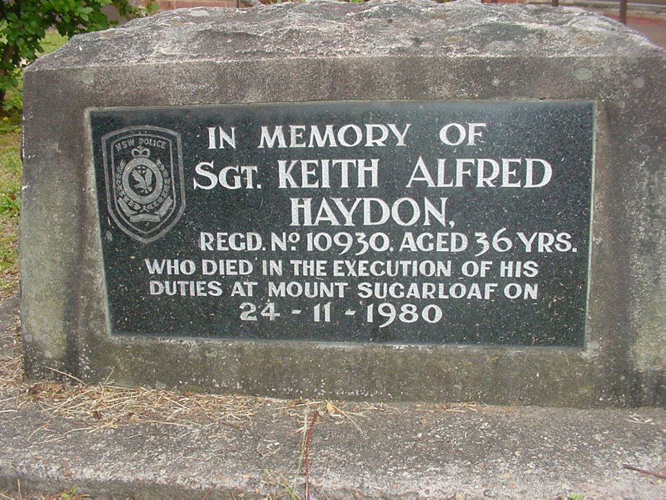 https://history.lakemac.com.au/page-local-history.aspx?pid=1085&vid=20&tmpt=showmedia&objid=25216 Plaque commemorating death of Sgt Keith Alfred Haydon in grounds of old West Wallsend Police Station - 10-12 Withers Street, West Wallsend.<br /> Photo Ref: 25216<br /> Creator: Clark, Mr Greg<br /> Sergeant. Keith Haydon was in charge of West Wallsend Police Station, when he was killed whilst on duty at Mt. Sugarloaf in 1980. This memorial plaque was originally placed at the spot where Sergeant Haydon was killed, but was relocated to the grounds of the West Wallsend Police Station after it was damaged by vandals. When the station closed in 2006, the plaque was moved to Waratah Police Station and rededicated in a service held 8th December 2006.<br /> Creative Commons License<br /> This work by Lake Macquarie City Library is licencsed under a CCA