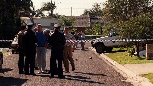 http://www.dailytelegraph.com.au/news/crescent-heads-police-killings-two-decades-on-ceremony-will-mark-sacrifice-made-by-senior-constables-on-duty/story-fni0cx4q-1227433992584 The scene in Walker Street, Crescent Head, the morning of the shootings, with the body of gunman John McGowan (right) covered by a sheet as police speak with shocked residents.