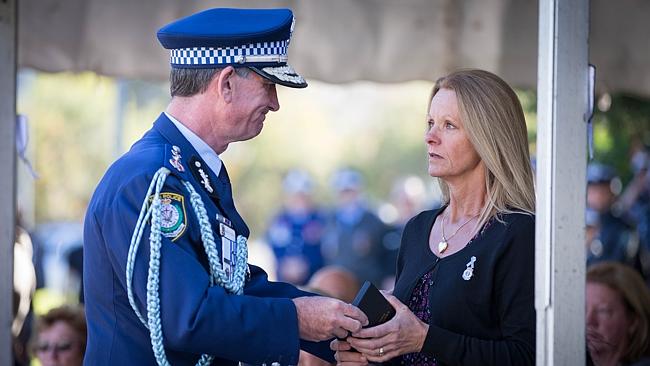 http://www.dailytelegraph.com.au/news/nsw/families-of-slain-officers-peter-addison-and-robert-spears-united-by-love/story-fni0cx12-1227435275075 Police Commissioner Andrew Scipione handing the National Police Service medal to Kathy Spears. Picture: Lindsay Moller