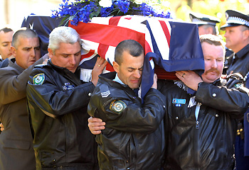 Selfless act of a courageous man ... police colleagues carry the coffin of Sen-Constable Paul Morris. Picture: Rob McKell