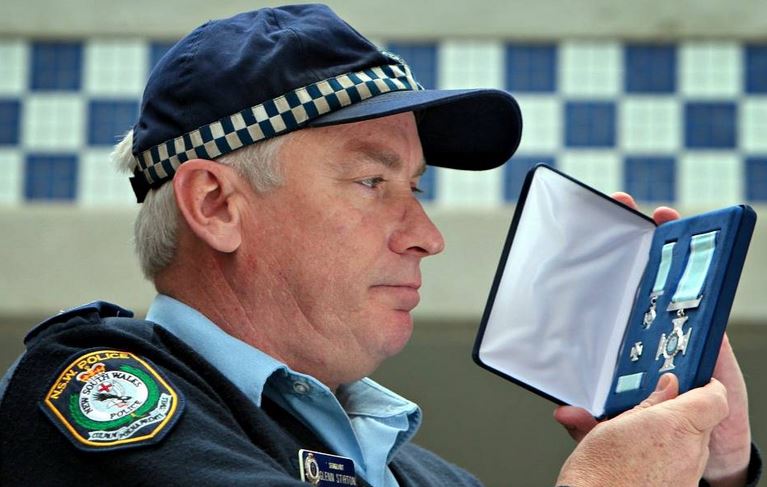 http://www.bordermail.com.au/story/1201522/death-of-decorated-albury-police-officer/ Sgt Glenn Stirton with his valour award in August 2012