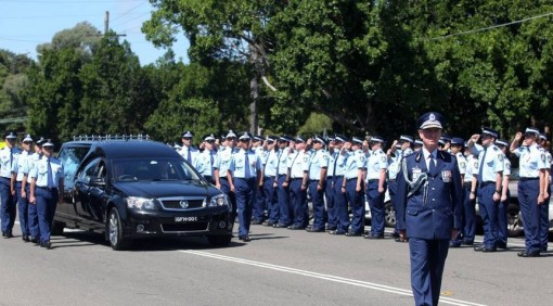 Last salute: NSW Police march at Cecil Abbott’s funeral at Penshurst yesterday. Below right, Mr Abbott. Picture: Chris Lane