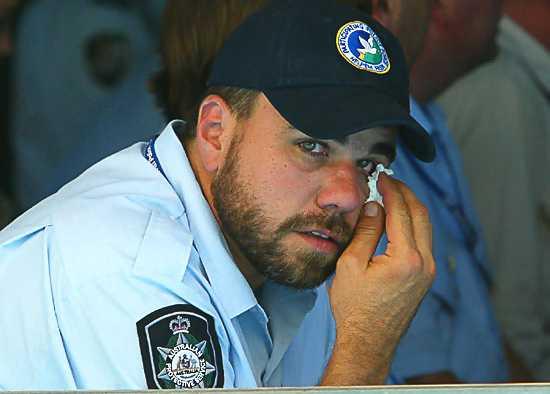 Australian Protective Services officer Robert Turnbull sheds a tear at the official wake in the compund before Adam Dunning's coffin flew back to Australia. Photo: Andy Zakeli