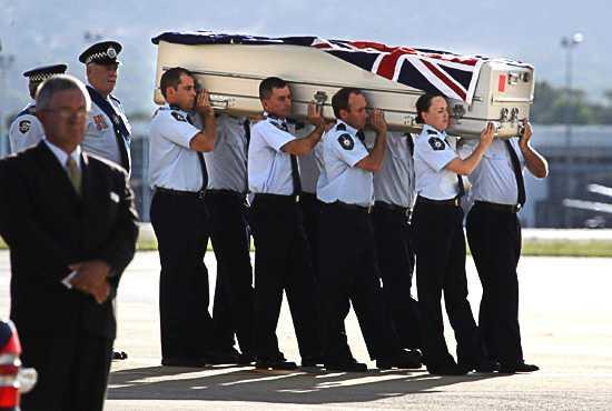 Adam Dunning's coffin is loaded from the aircraft to a hearse at the RAAF Base at Fairbairn. Photo: Andrew Tayl