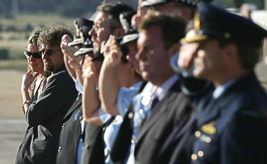 The girlfriend of Adam Dunning, Elise Wiscombe (far left), cries as police salute the farewell of the coffin. Photo: Andrew Taylor