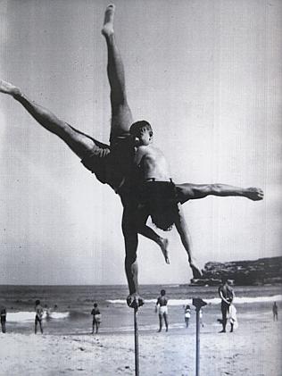 Harris holds his son on Bondi beach.
