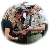 Huitsons widow Lisa receiving her husband’s police cap and National Medal Award from the police commissioner