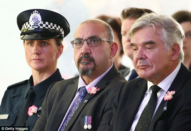 Former police member Carl Donadio ( centre )who was injured in the blast looks on during a memorial service to honour Constable Taylor