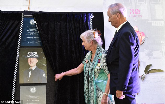 Constable Taylor's parents unveil a plaque in her honour in the RMIT Alumni Courtyard in Russell Street in Melbourne