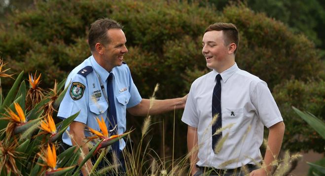 TOUCHED: Port Stephens Superintendent Chris Craner thanks Tom Finlay for his poem about police killed in the line of duty. Picture: Jonathan Carroll.