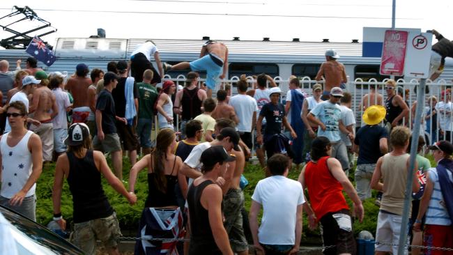 Hundreds of people jumped the fence to storm the train station. Picture: Craig Greenhill