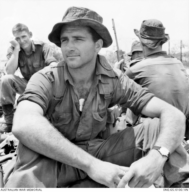 https://www.awm.gov.au/collection/DNE/65/0100/VN/ Bien Hoa, Vietnam. 1965-07. Private Peter Dorter of Perth, WA, relaxes at the edge of the airfield after an operation by the 1st Battalion, The Royal Australian Regiment (1RAR).