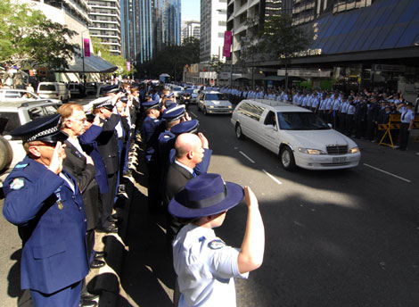 Queensland Police line the streets in a guard of honor for Constable Brett Andrew Irwin while his casket is escorted from the St Stephens Cathedral in Brisbane. Picture: AAP/Tony Phillips