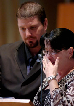 Sister of Constable Brett Andrew Irwin reads a eulogy for her brother while her Husband Ben provides support. Picture: AAP/Tony Phillips