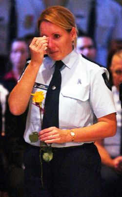 An emotional Ferny Grove Police station officer at the funeral of her collegue Constable Brett Andrew Irwin. Picture: AAP/Tony Phillips
