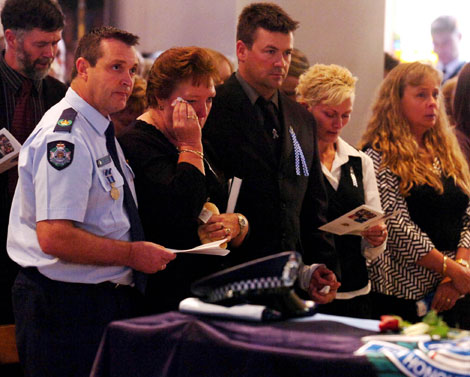Ferny Grove Police station officer in charge Andy Graham (left) with Constable Brett Andrew Irwin's mother Chris Irwin (centre), brother Mick Irwin and family during the officer's funeral at the St Stephens Cathedral. Picture: AAP/Tony Phillips