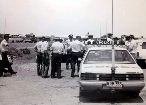https://police.freom.com/john-hardaker/ ?<br /> New South Wales Historic Patrol Vehicles<br /> 071119 ·<br /> This picture is of John Hardaker and other officers. Location - Broken Hill, Mitch Hardaker, Johns son, was told that this was taken whilst Mad Max 3 was being filmed out there. You can see the old bus on the left of the picture.
