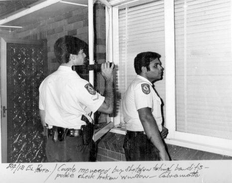 Cst 1/c Greg Callander & Constable Nabil Elias at a crime scene in Cabramatta where a couple were menaced by stotgun toting bandits. Around 1980.