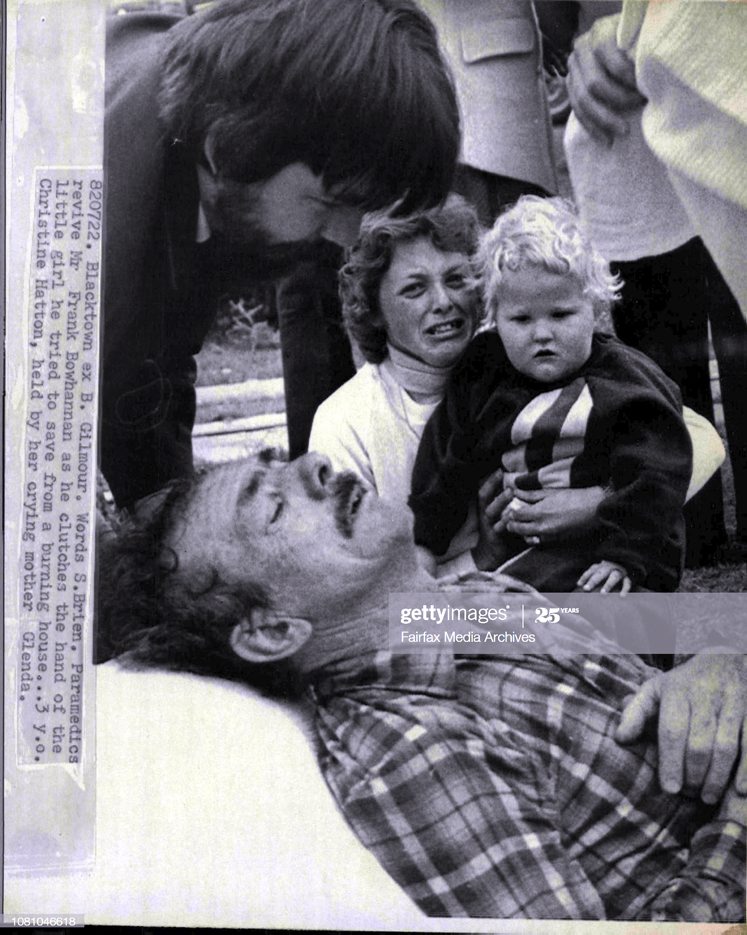 https://www.gettyimages.com.au/detail/news-photo/paramedics-revive-mr-frank-bowhannan-as-he-clutches-the-news-photo/1081046618 Paramedics revive Mr. Frank Bowhannan as he clutches the hand of the little girl he tried to save from a burning house... 3 y.o. Christine Hatton, held by her crying mother Glenda.A Little girl wept today for an old man who had twice risked his life entering a blazing house trying to save her.Mr. Frank Bowhannan, of First Avenue, Seven Hills, thought his next door neighbour's child, Christine Hatton, 3, had been trapped in the house.He and policeman Const. Jeff Bakhuizen twice entered the house searching for Christine before they were forced out by intense heat and smoke. July 22, 1982. (Photo by Barry James Gilmour/Fairfax Media via Getty Images).<br />