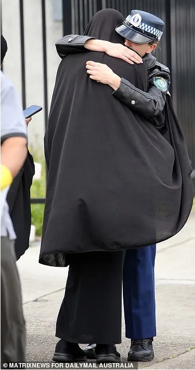 Tanzeel Iftikhar BASHIR. Constable Tanzeel Bashir’s mother Rani (left and right) was comforted by her son’s grief-stricken colleagues at the funeral and burial.