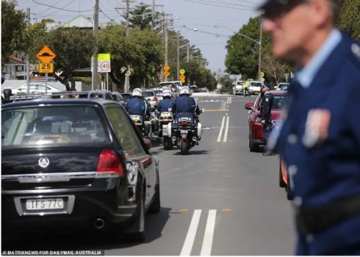 Tanzeel Iftikhar BASHIR. Constable Tustas (right, near red car) stood alone on the road and raised one last salute as Constable Tanzeel Bashir’s hearse passed by.