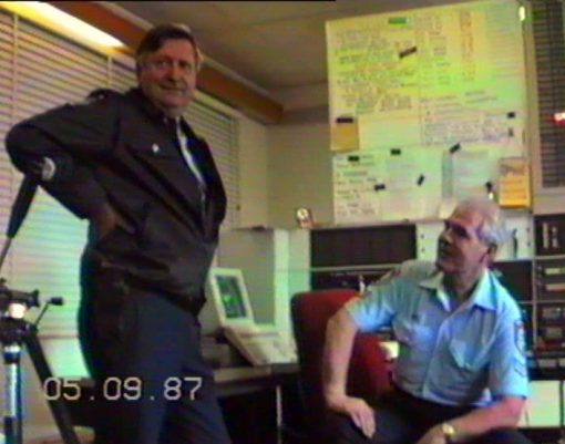 THESE PHOTOS ARE 'GRABBED' FROM VIDEO TAPE FROM 'VARIOUS 4' OF THE COLLECTION OF GREG CALLANDER.<br /> 1987 - 1988<br /> <br />Video transferred to DVD on 230206<br /> <br />SENIOR CONSTABLE <strong><a href="https://police.freom.com/karl-hanson/" target="_blank" rel="noopener noreferrer">KARL HANSON</a></strong> # 8870 (SEATED), VKG2, WARILLA POLICE RADIO - SENIOR OPERATIONS OFFICER - SPEAKING WITH SENIOR SERGEANT <a href="https://police.freom.com/richard-alan-brook/" target="_blank" rel="noopener noreferrer"><strong>DICK BROOK</strong></a> # 9570, FROM WARILLA POLICE STATION.<br /> <br /> 1987 - 1988